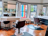 a hair salon with chairs and a window